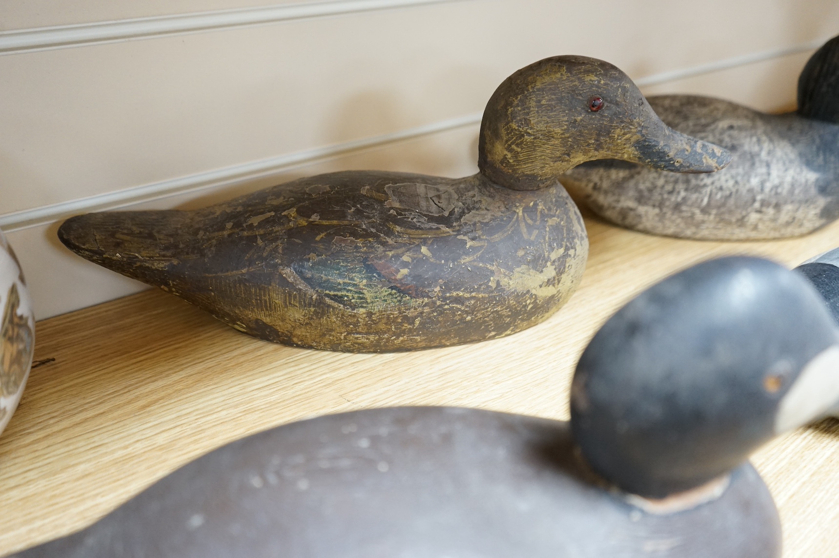 A group of four 19th and 20th century wooden decoy ducks, largest 39cm wide. Condition - fair